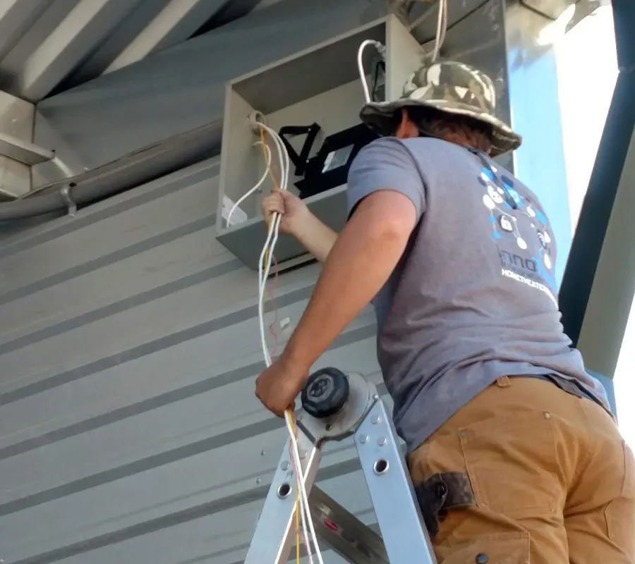 man on ladder doing home wiring