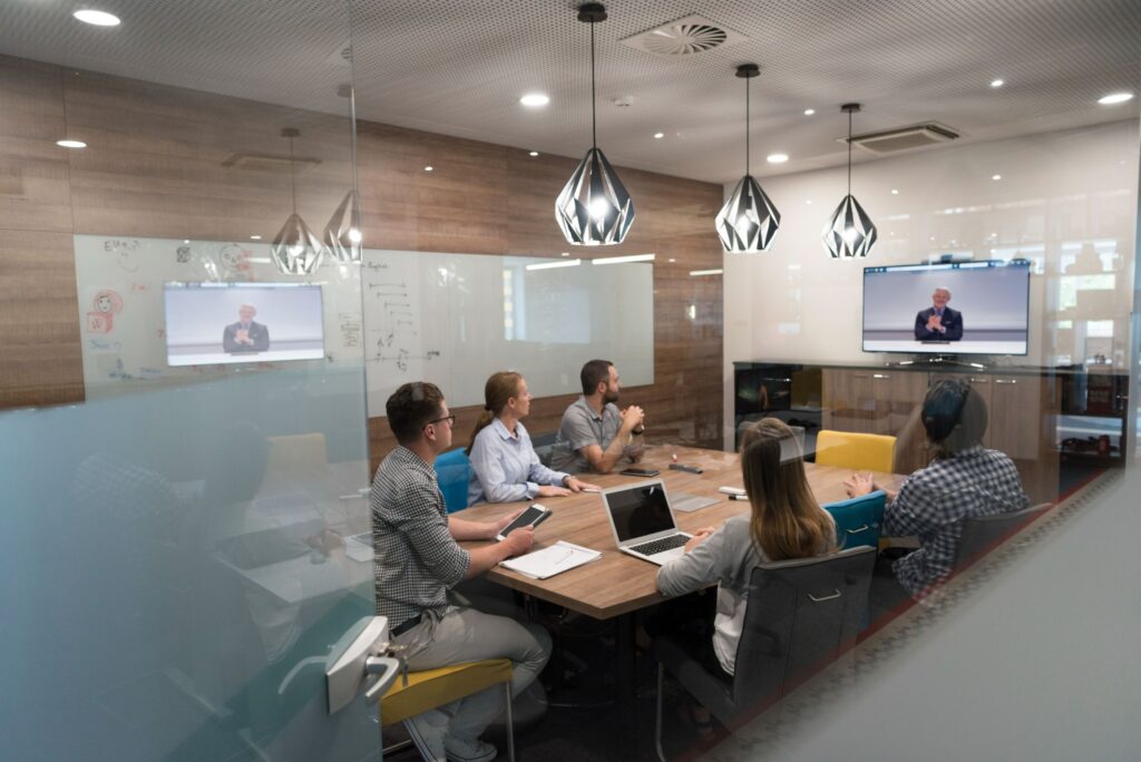 colleagues gathered around a table during video conference